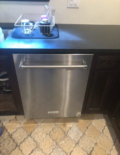 A stainless steel dishwasher in a kitchen.