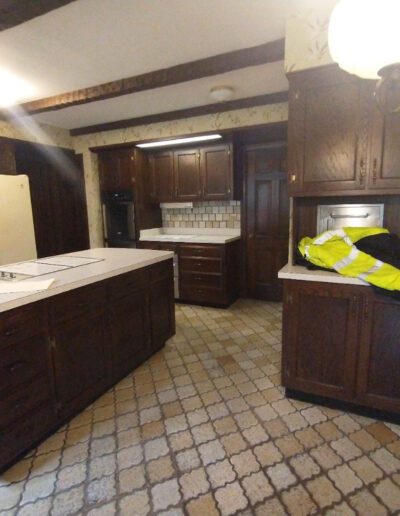 A kitchen with brown cabinets and a tile floor.