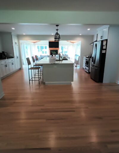 A kitchen with hardwood floors and a kitchen island.