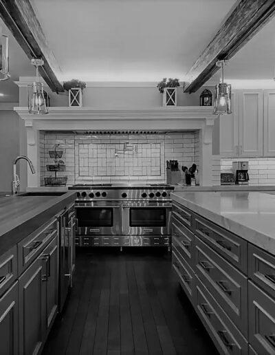 A black and white photo of a kitchen.